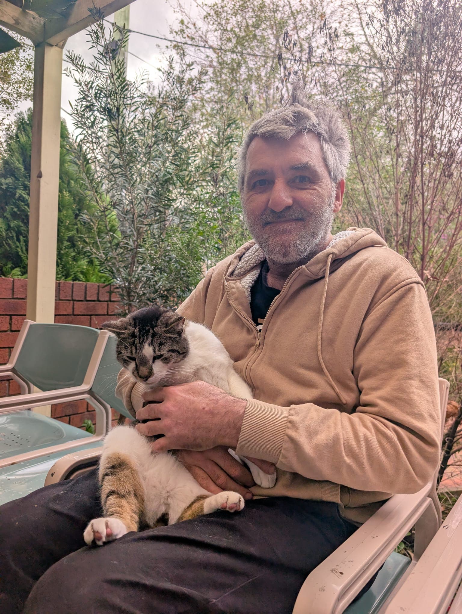 Resident relaxing with the house cat in the garden
