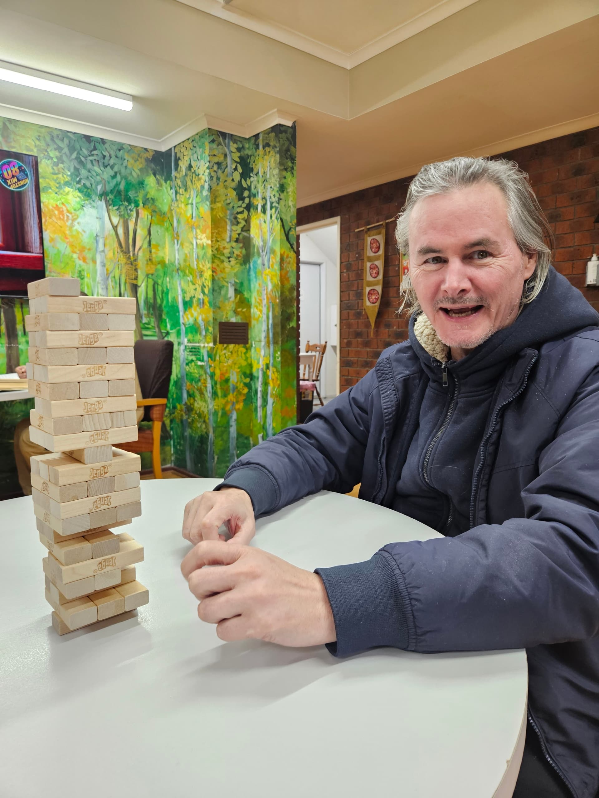 Resident enjoying a game of Jenga in the lounge