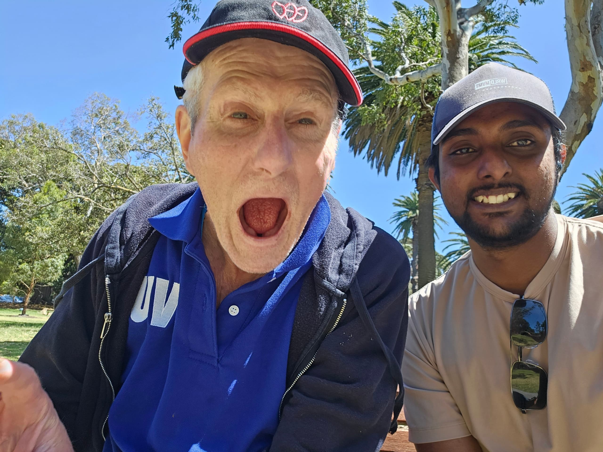 Resident and carer having a laugh at the park