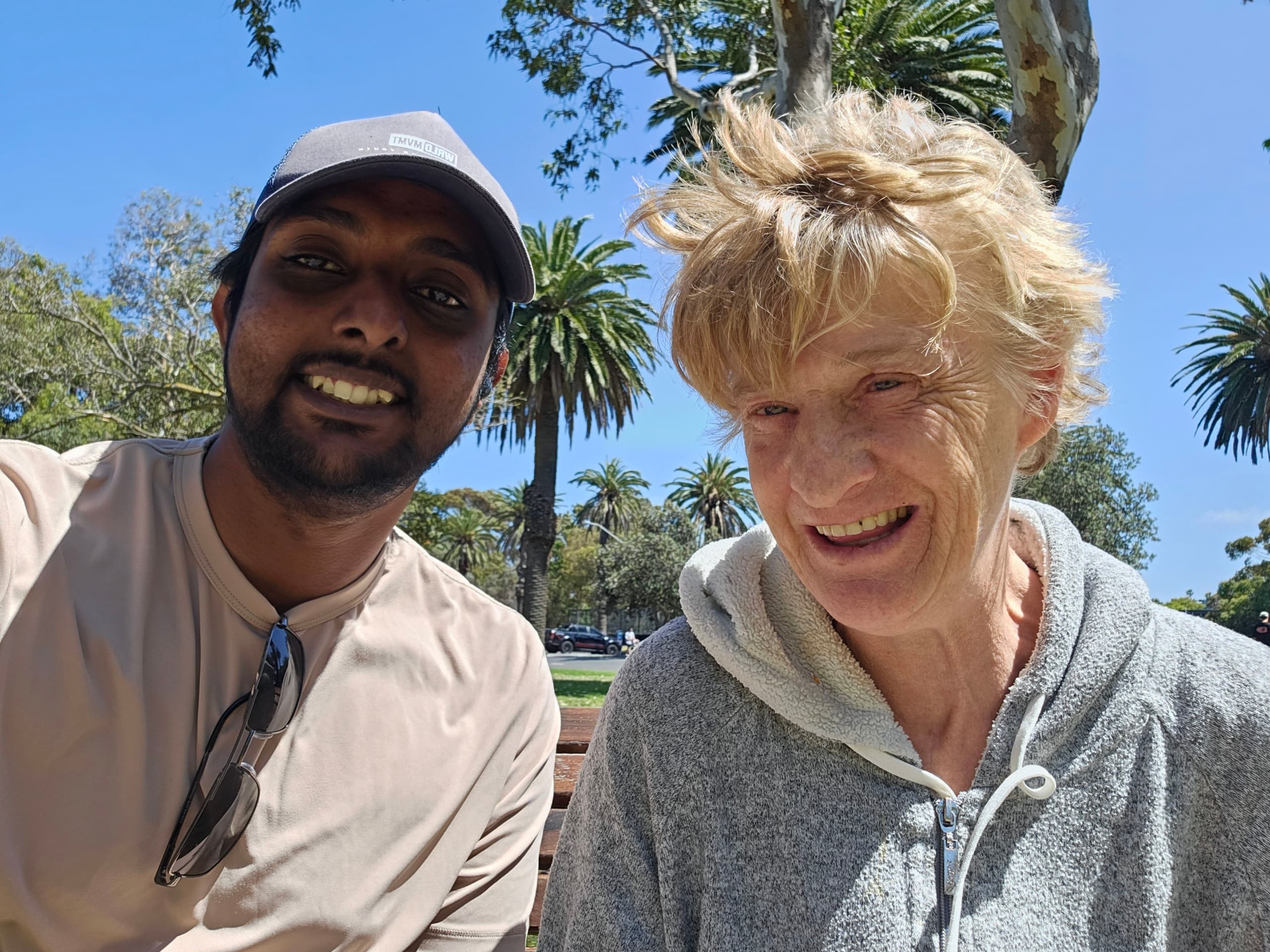 Resident and carer enjoying a sunny day at the park