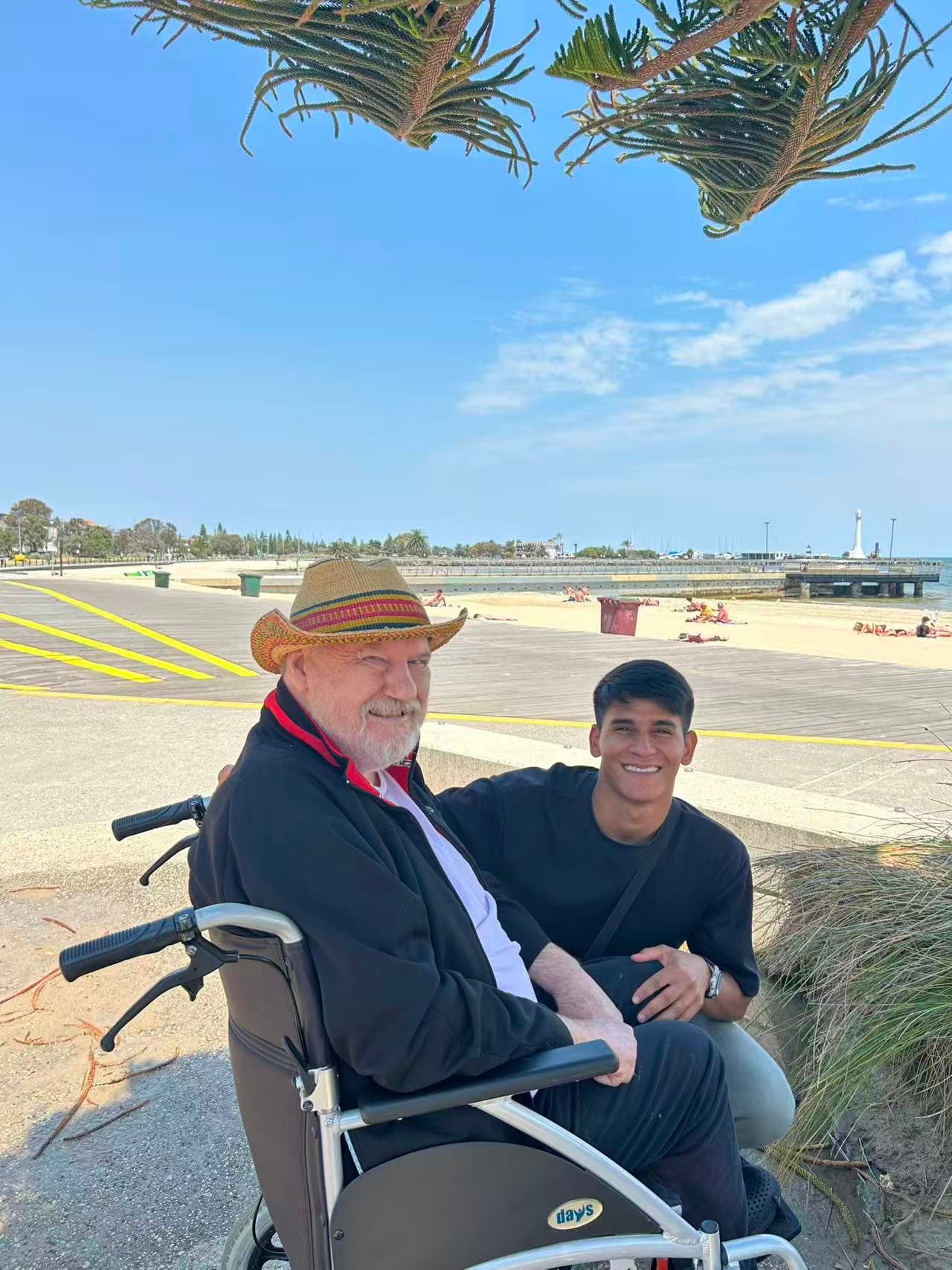 Resident and carer enjoying a day at St Kilda beach