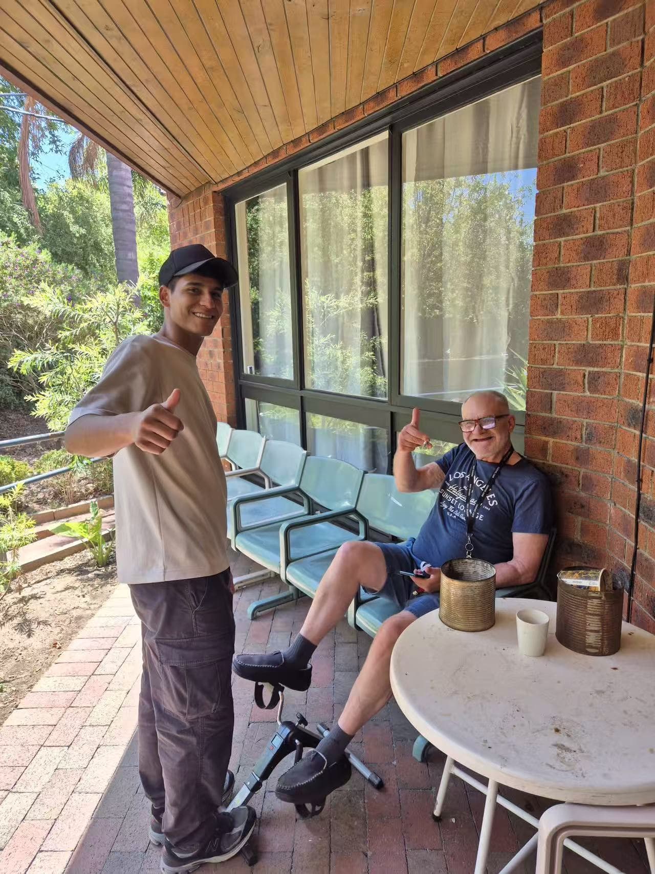 Resident and carer enjoying a coffee on the verandah