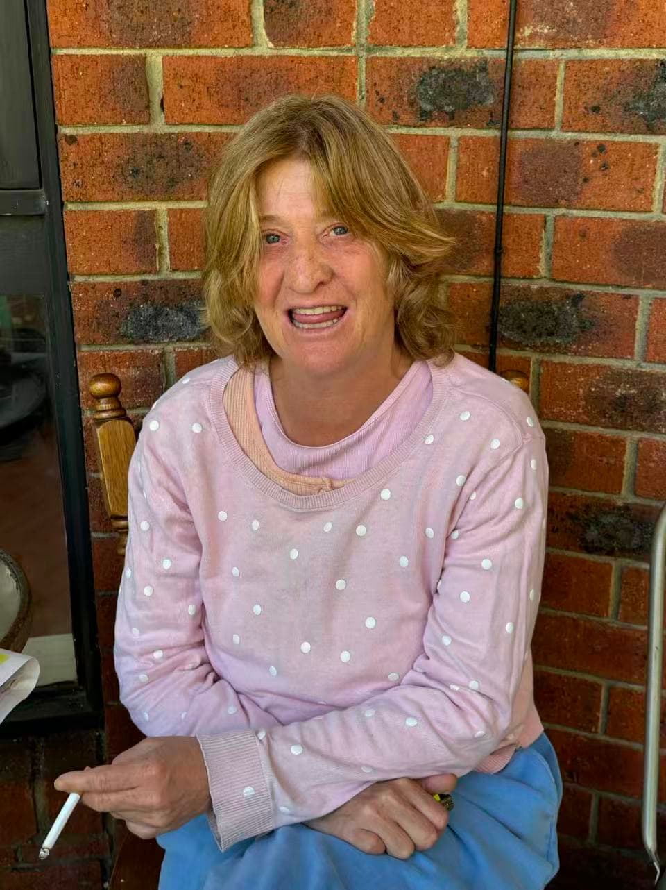 Resident smiling on the verandah