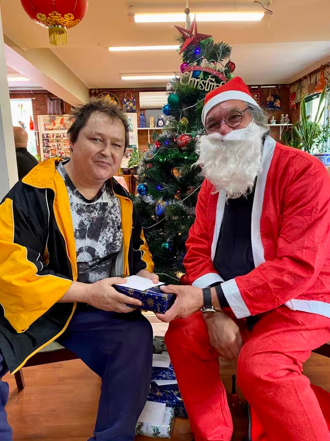 Santa delivering Christmas presents to a resident